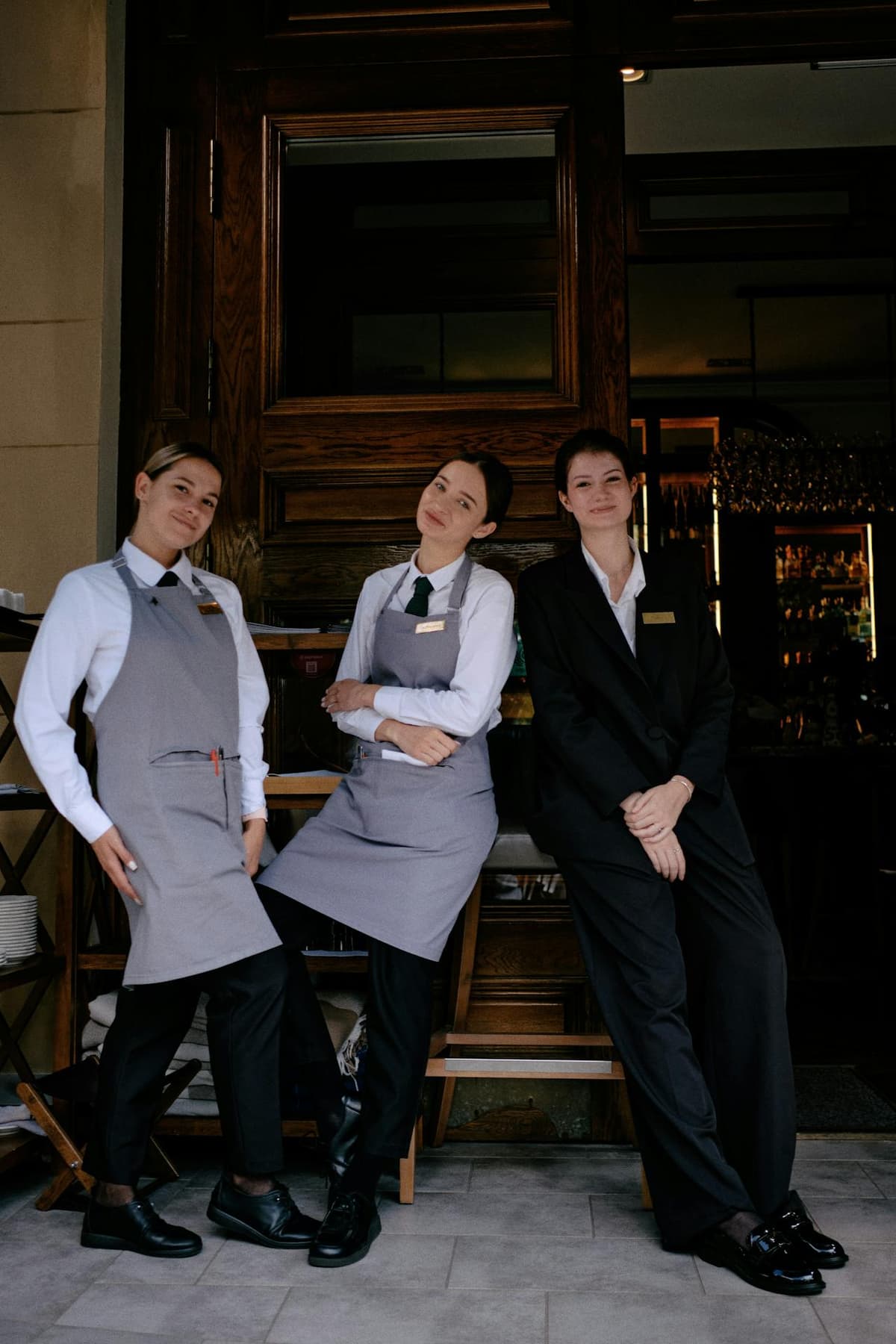 A restaurant host welcoming guests at the front of house