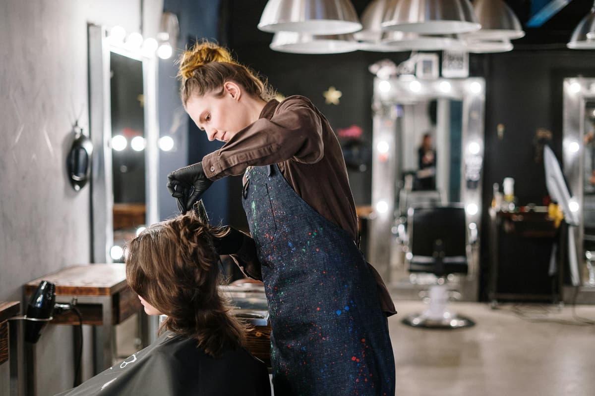 A stylist working with a client in a salon